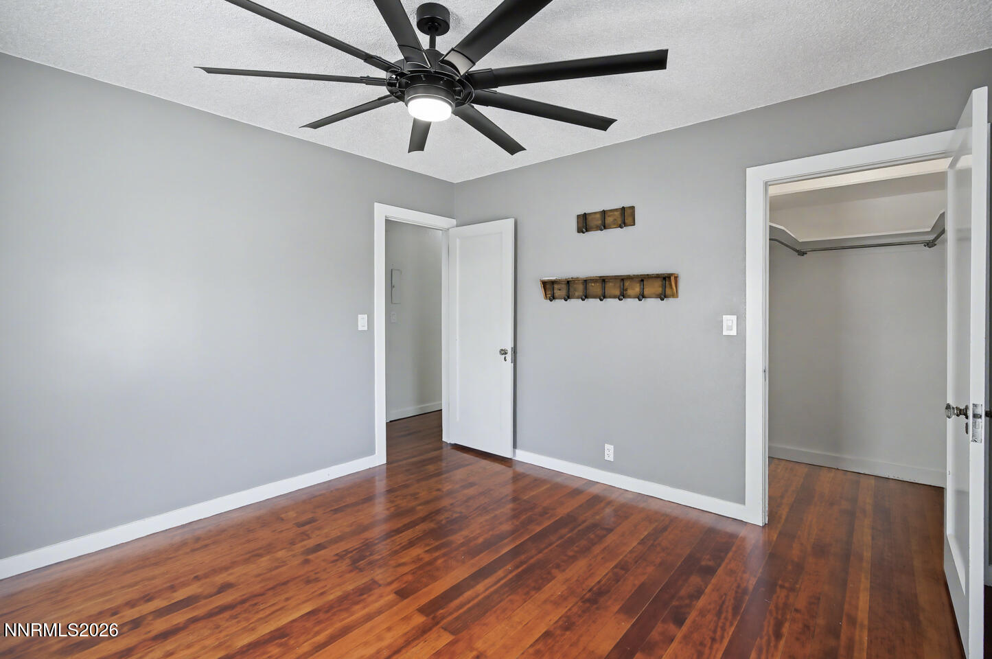 65 South Bailey Street Fallon, NV 89406 - Photo 14 of 34 an empty room with wooden floor and windows