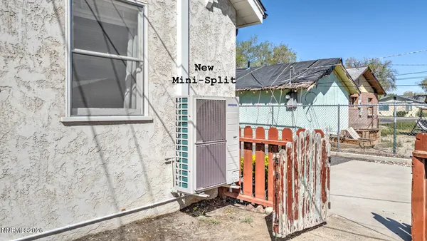 a view of a house with wooden fence