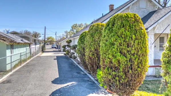 a view of a house with a balcony and yard