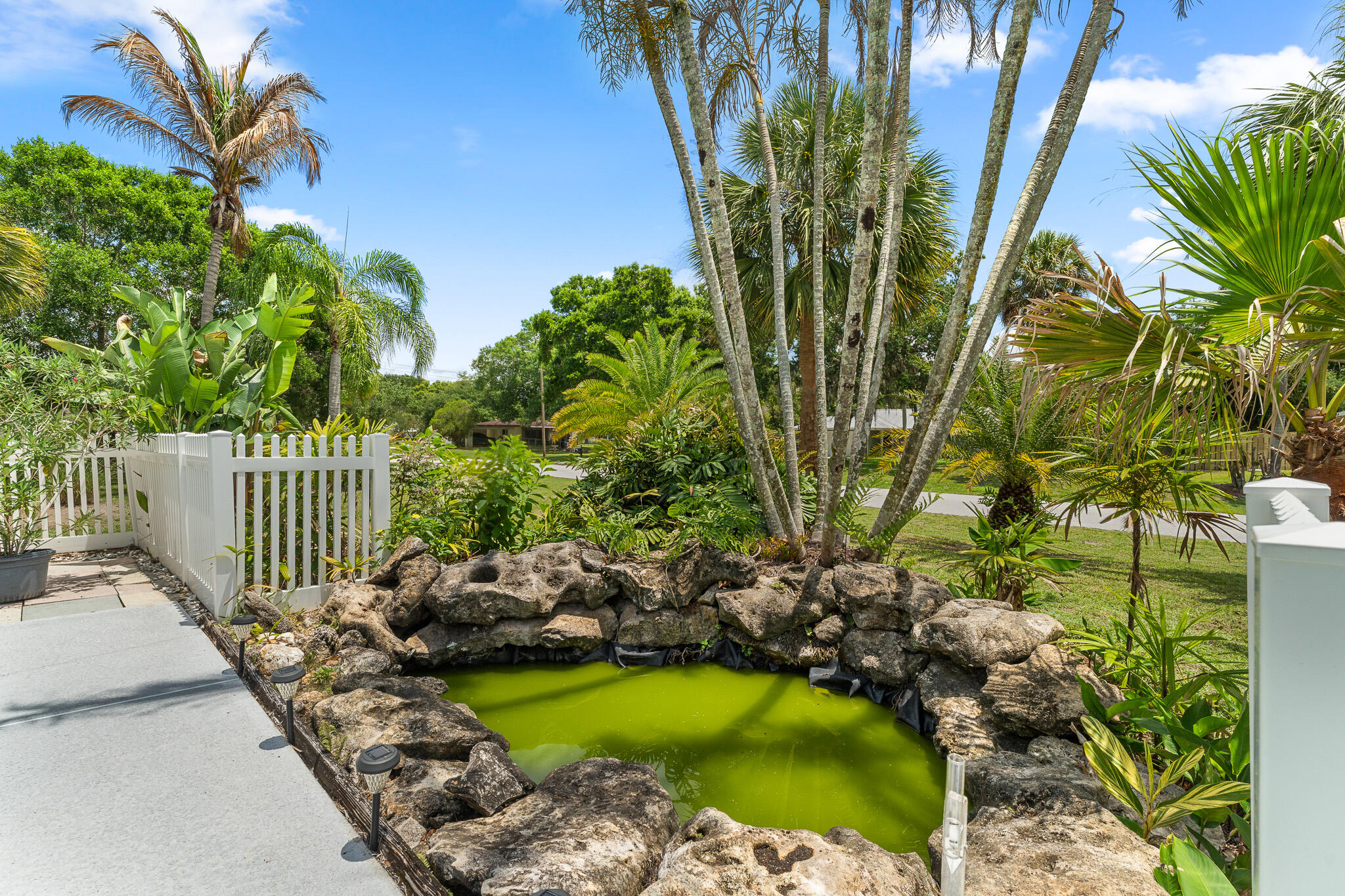 1653 Southwest 85th Terrace Stuart, FL 34997 - Photo 44 of 54 a view of swimming pool from a garden