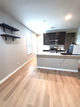 a view of a kitchen with a sink and a microwave