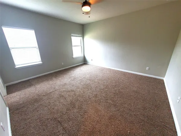 an empty room with windows and closet