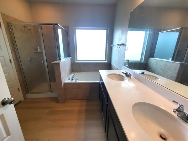 a bathroom with a tub sink and mirror