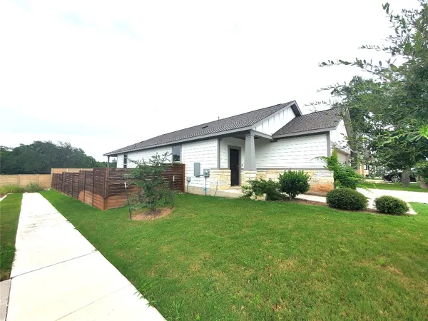a view of a house with a yard and sitting area