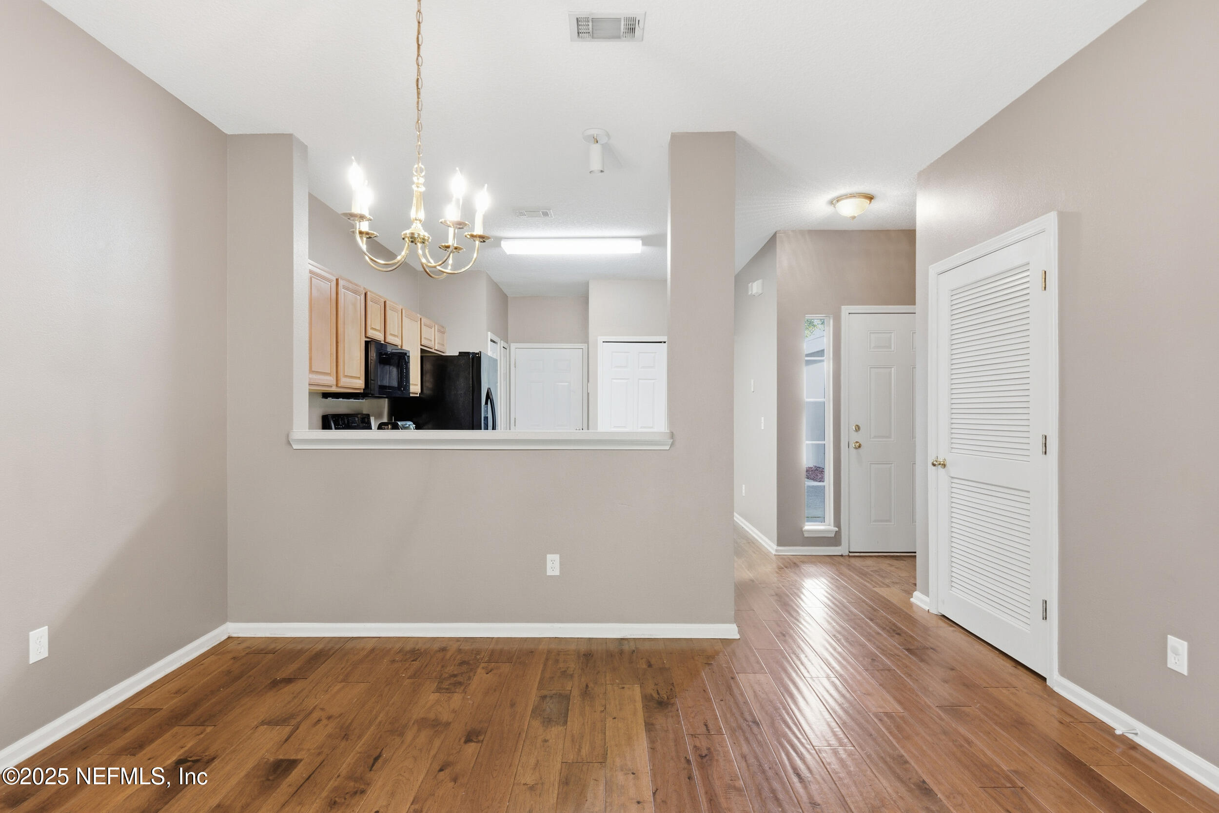 216 Scrub Jay Drive St. Augustine, FL 32092 - Photo 11 of 27 a view of a livingroom with a chandelier fan and wooden floor