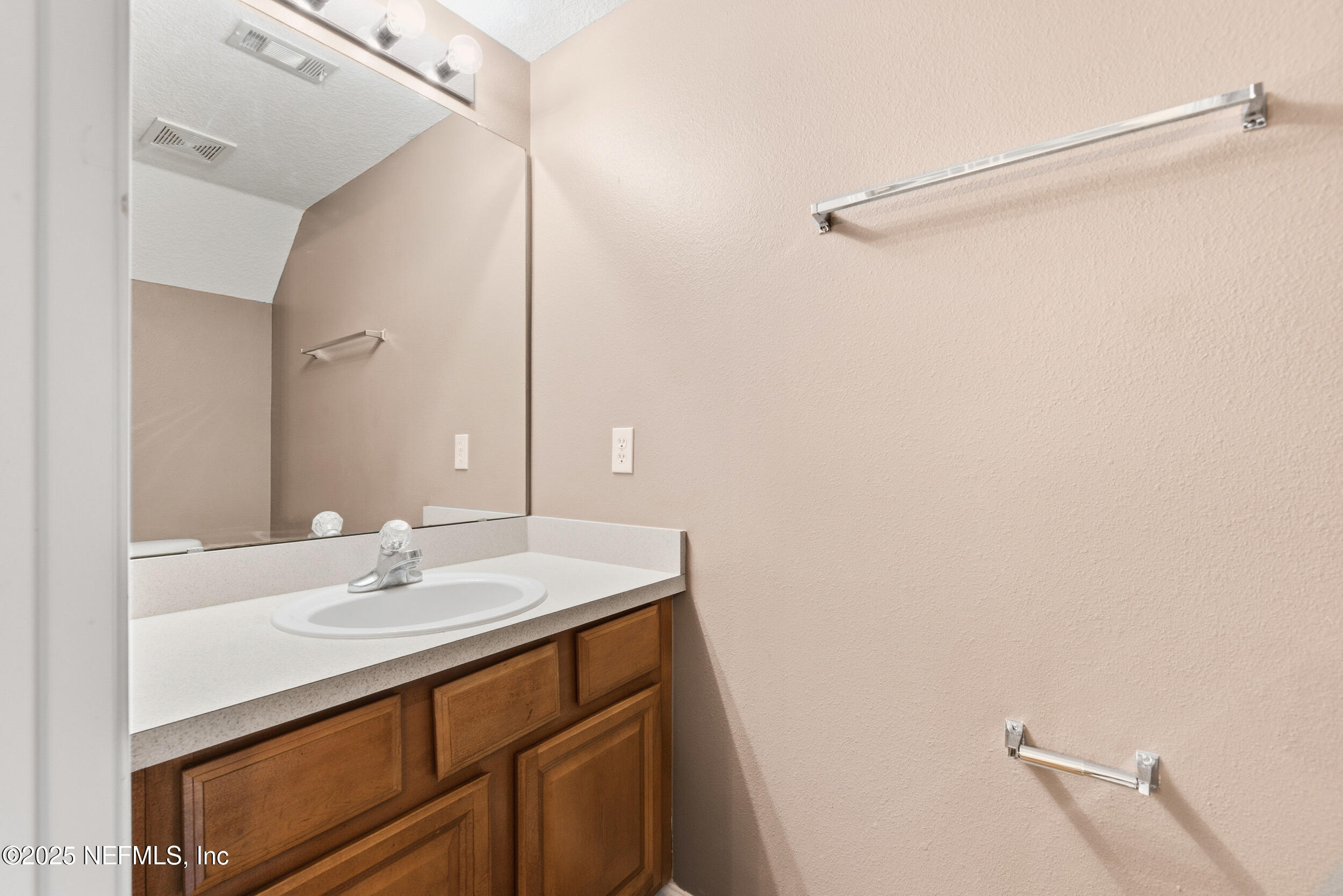 216 Scrub Jay Drive St. Augustine, FL 32092 - Photo 12 of 27 a bathroom with a sink and a mirror