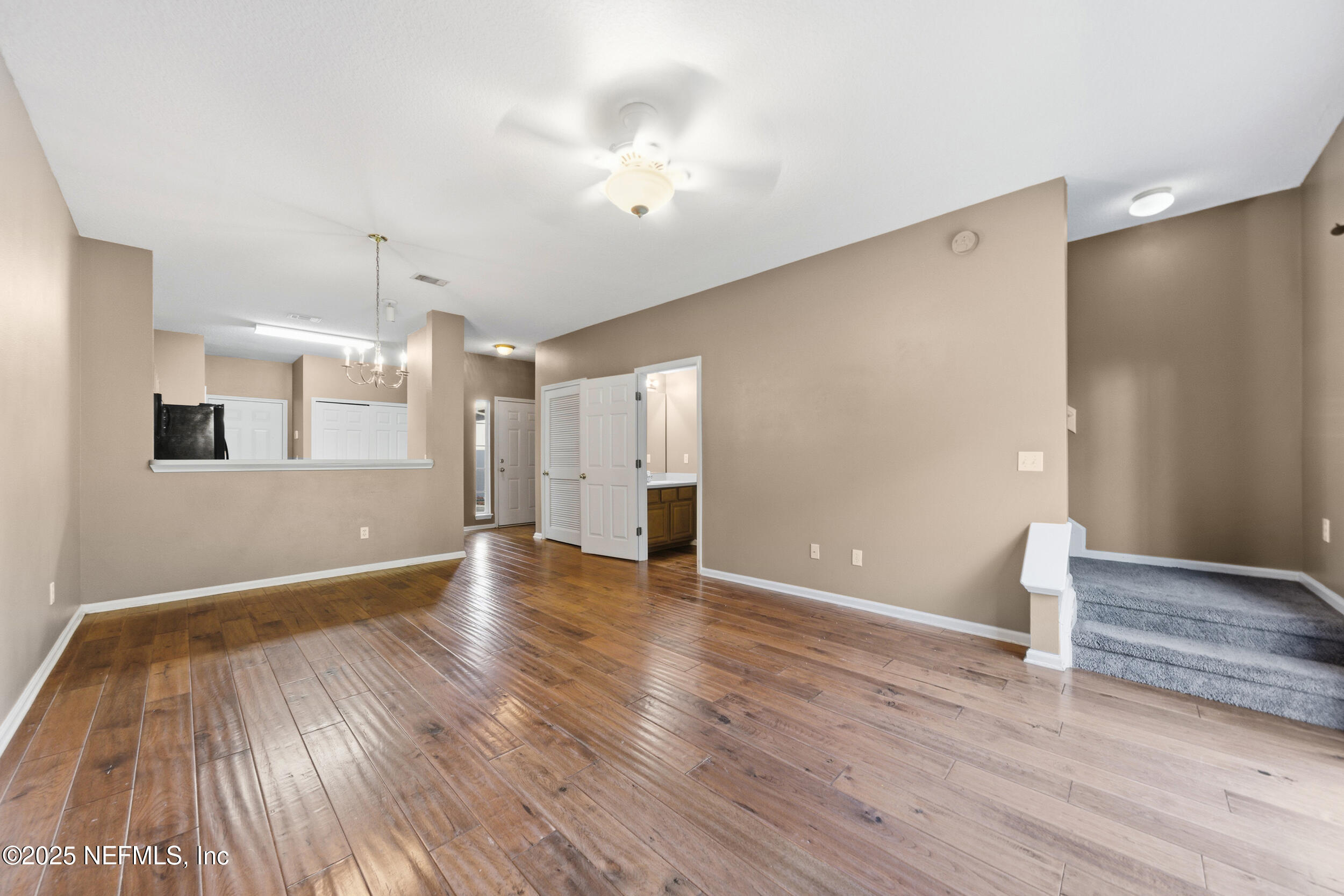 216 Scrub Jay Drive St. Augustine, FL 32092 - Photo 14 of 27 a view of an empty room with wooden floor and a window