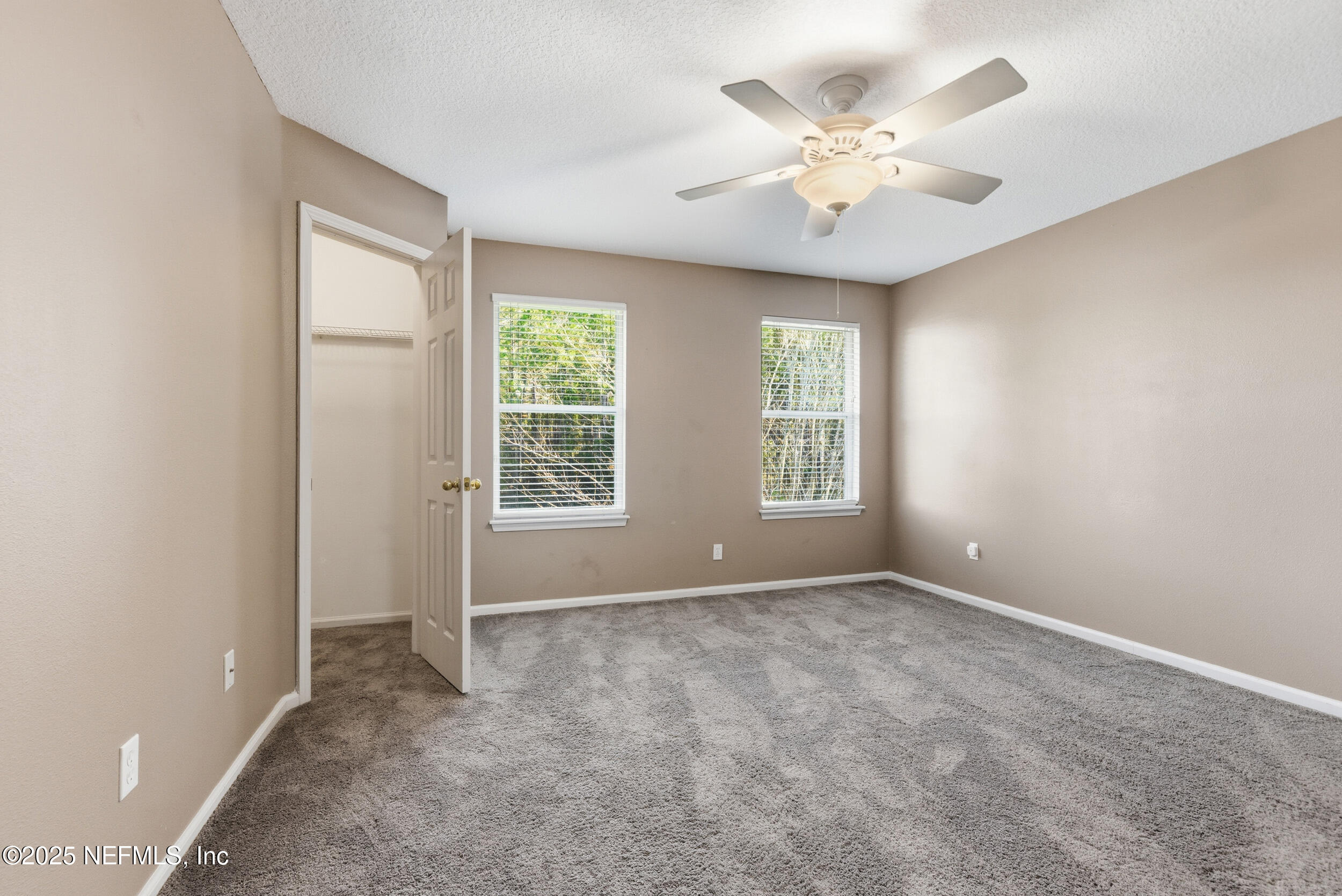 216 Scrub Jay Drive St. Augustine, FL 32092 - Photo 18 of 27 an empty room with windows and ceiling fan