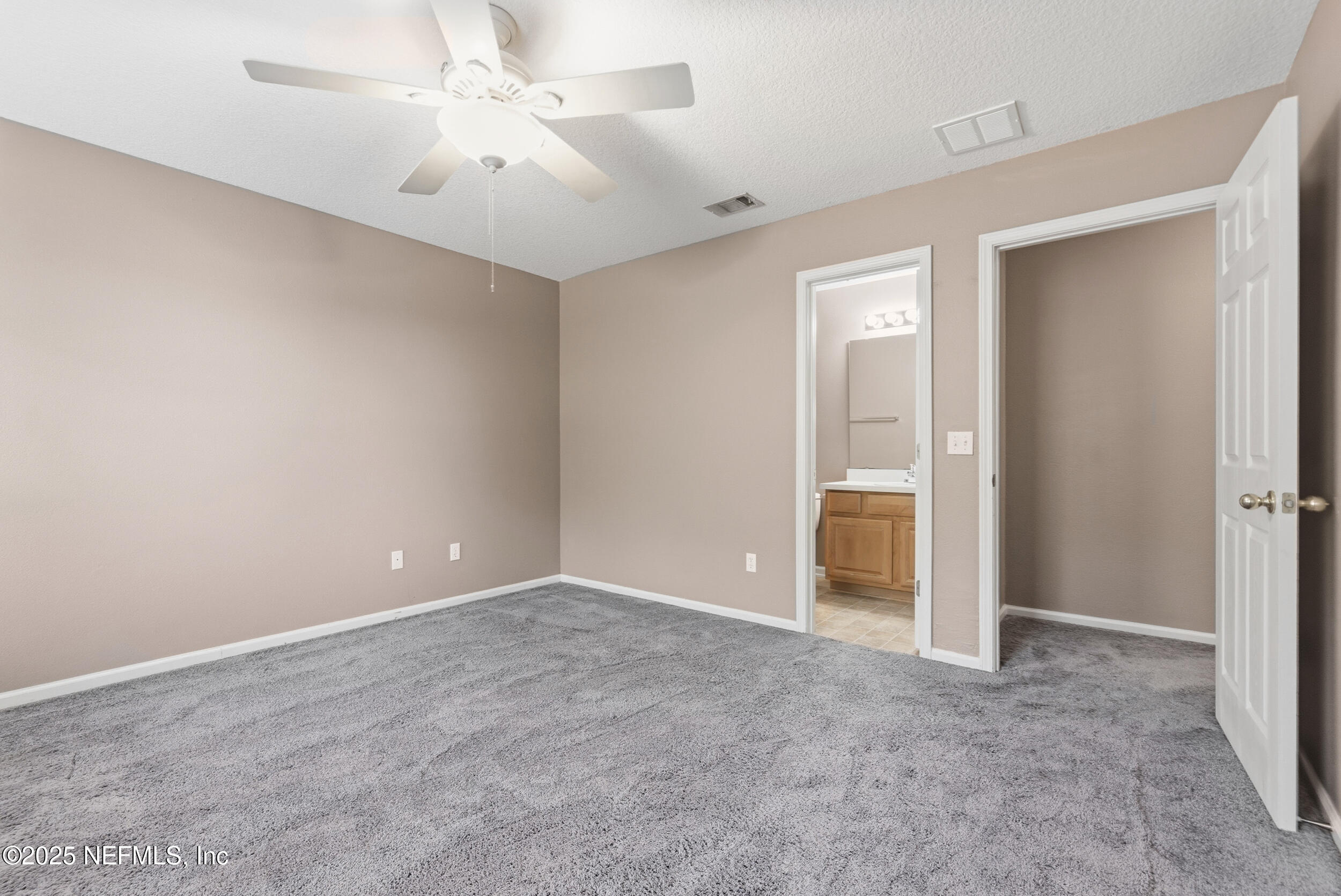 216 Scrub Jay Drive St. Augustine, FL 32092 - Photo 19 of 27 a view of an empty room with a ceiling fan