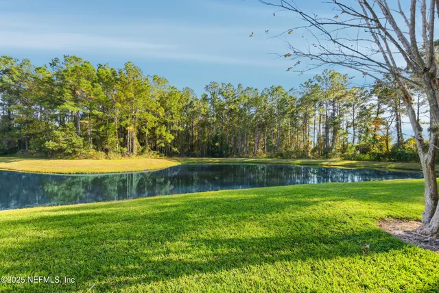a view of yard with swimming pool and green space