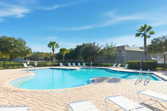 a view of a swimming pool and lounge chair