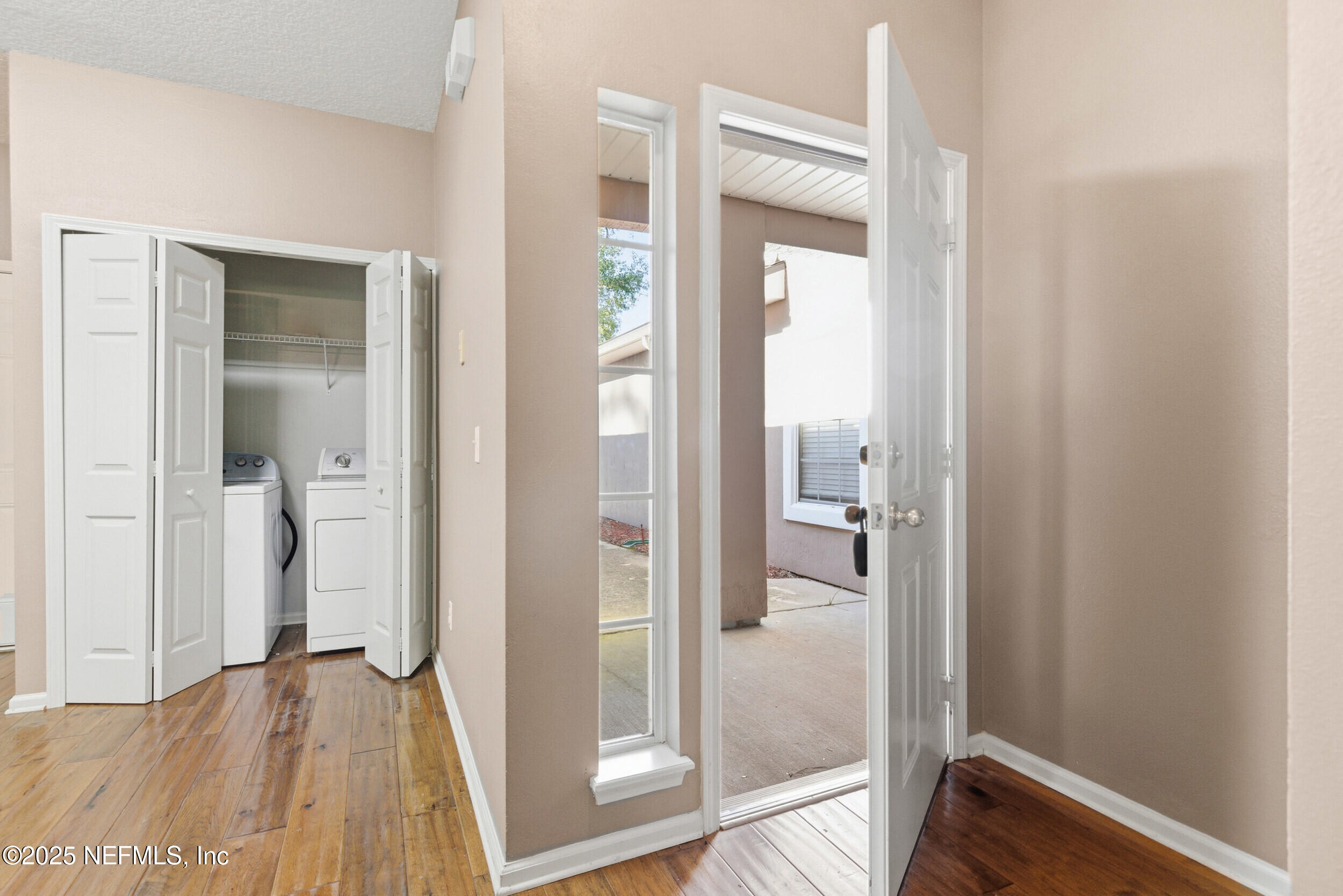 216 Scrub Jay Drive St. Augustine, FL 32092 - Photo 5 of 27 a view of a hallway with wooden floor and a bathroom