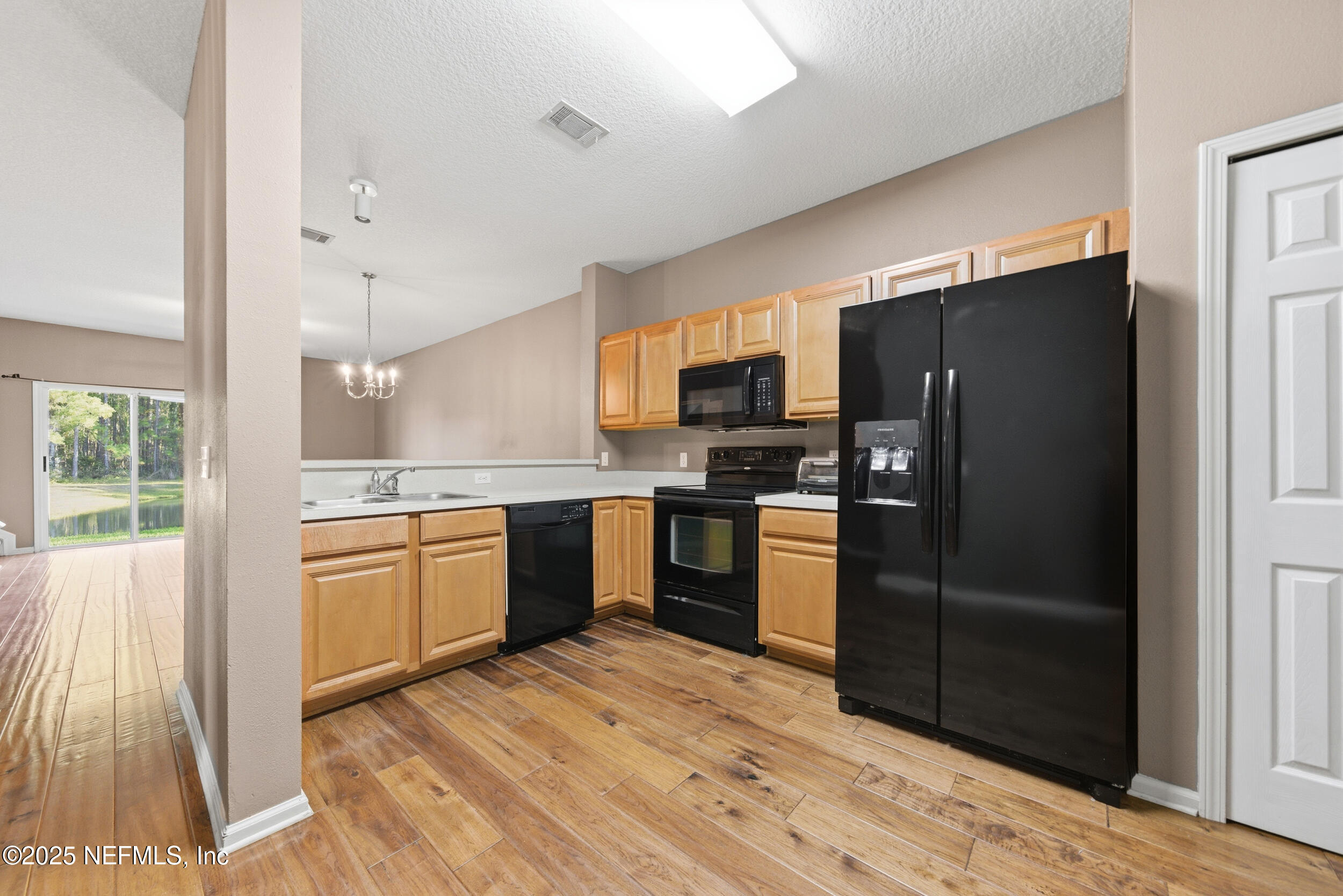 216 Scrub Jay Drive St. Augustine, FL 32092 - Photo 8 of 27 a kitchen with stainless steel appliances granite countertop a refrigerator and a stove top oven