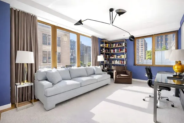 a living room with furniture and a chandelier