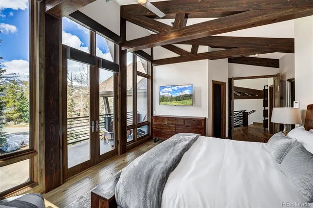 a bed sitting in a bedroom next to a large window