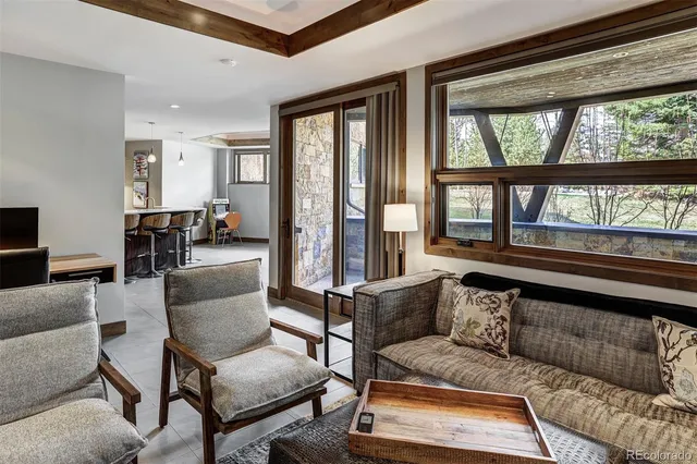 a living room with furniture and a floor to ceiling window