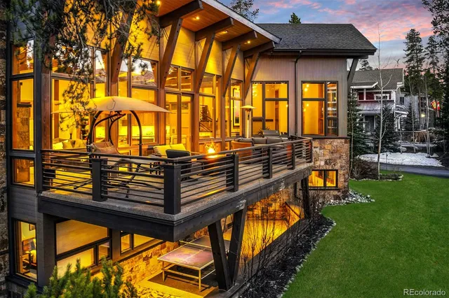 a backyard of a house with barbeque oven table and chairs
