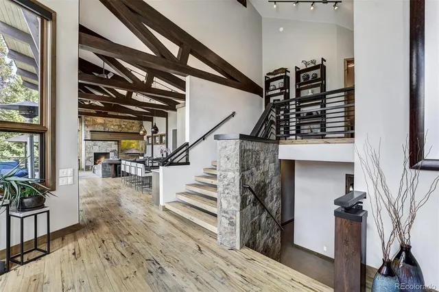 a view of entryway and hall with wooden floor