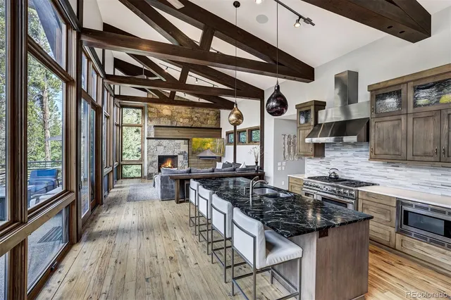 a kitchen with stainless steel appliances granite countertop a stove and a wooden cabinets