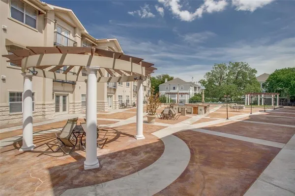 a view of a brick building next to a yard