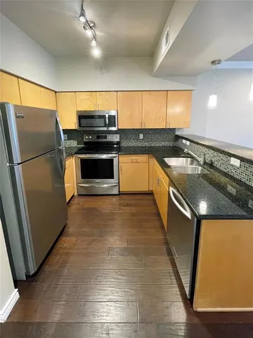 a kitchen with a refrigerator and a sink