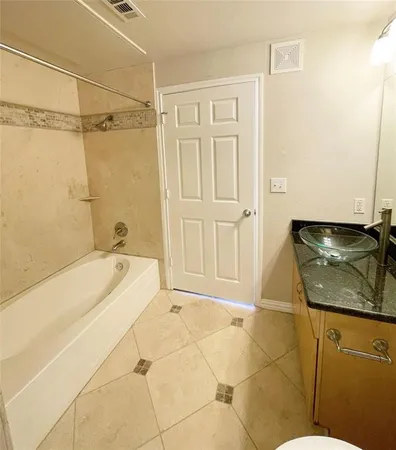 a bathroom with a bathtub and shower