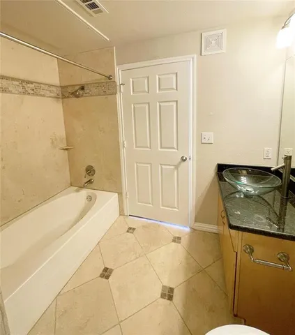 a bathroom with a bathtub and shower