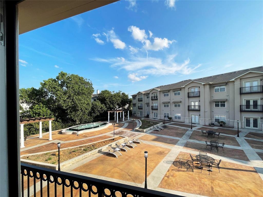 3102 Kings Road, Unit 2208 Dallas, TX 75219 - Photo 18 of 19 a view of a patio with a table and chairs