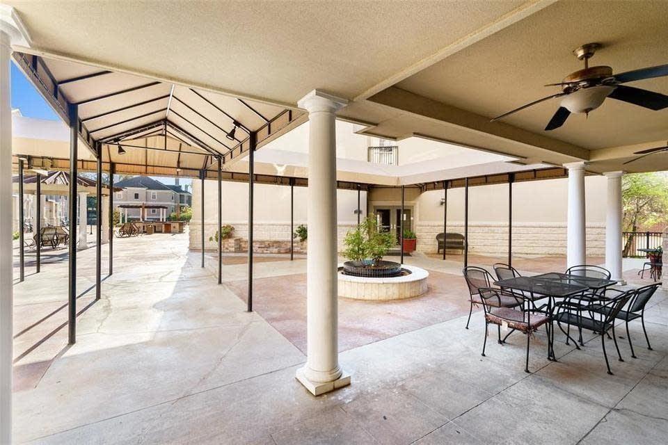3102 Kings Road, Unit 2208 Dallas, TX 75219 - Photo 4 of 19 a view of a patio with a table and chairs
