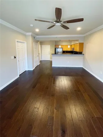 a view of empty room with wooden floor