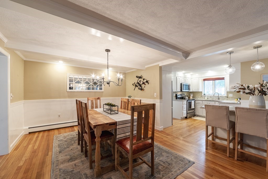 63 Maple Ridge Road Reading, MA 01867 - Photo 11 of 41 a view of a dining room with furniture and wooden floor