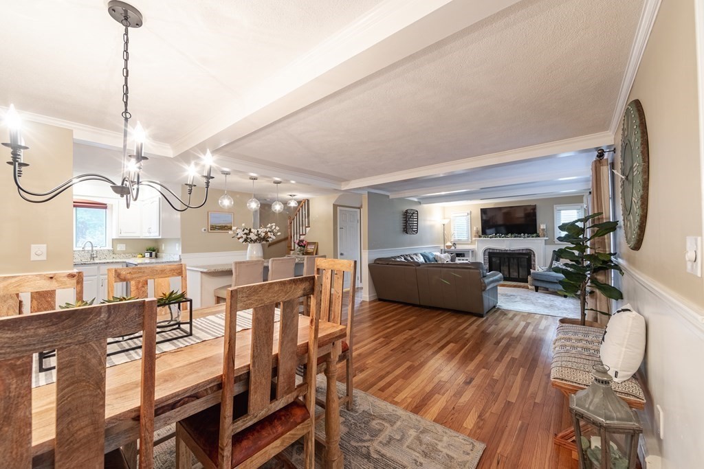 63 Maple Ridge Road Reading, MA 01867 - Photo 12 of 41 a living room with lots of furniture and a chandelier