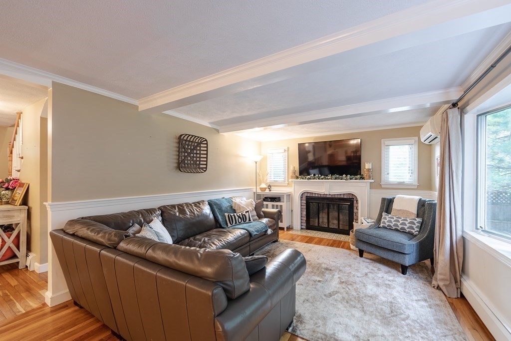 63 Maple Ridge Road Reading, MA 01867 - Photo 14 of 41 a living room with furniture and a fireplace