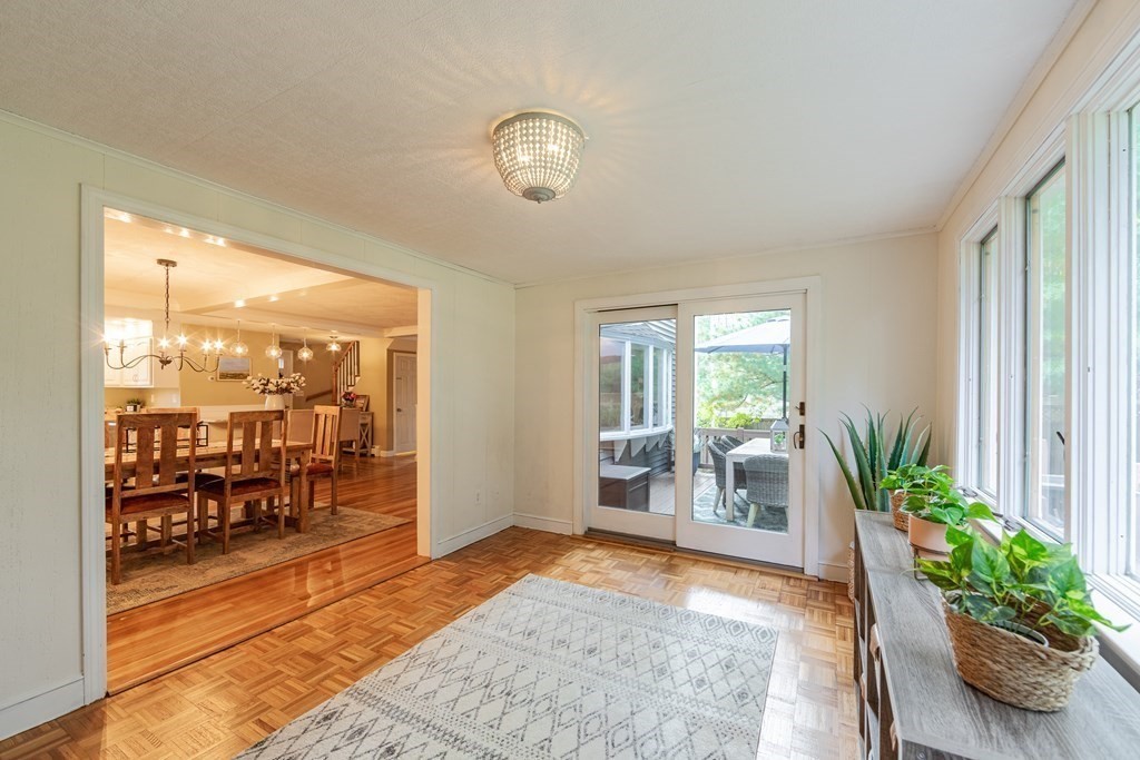 63 Maple Ridge Road Reading, MA 01867 - Photo 18 of 41 a view of an entryway with wooden floor and a potted plant