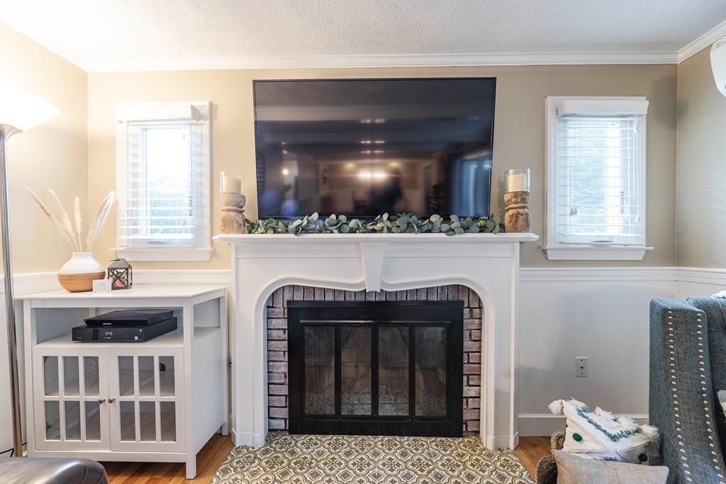 63 Maple Ridge Road Reading, MA 01867 - Photo 20 of 41 a living room with furniture and a fireplace