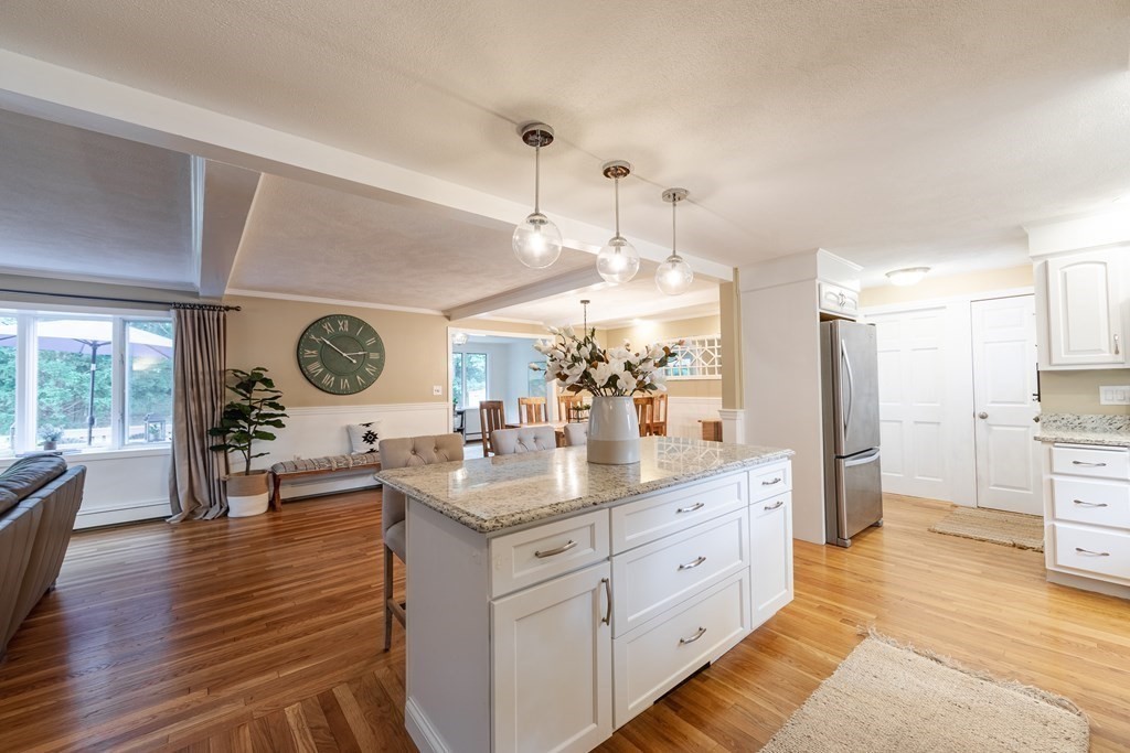 63 Maple Ridge Road Reading, MA 01867 - Photo 22 of 41 a very nice looking room with kitchen island furniture and a large window