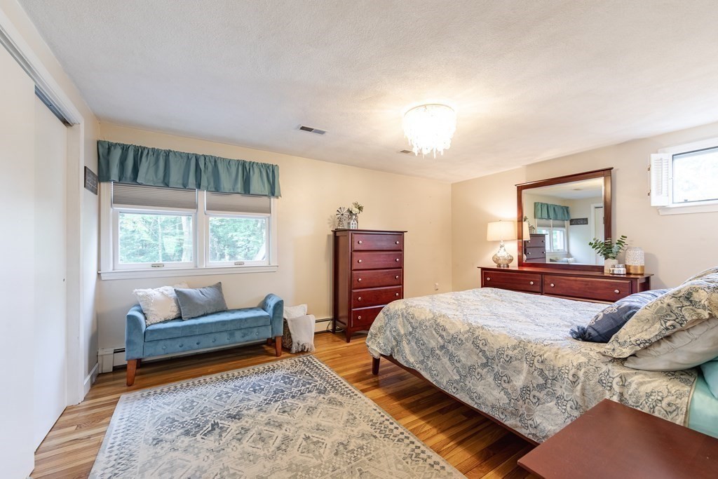63 Maple Ridge Road Reading, MA 01867 - Photo 25 of 41 a bedroom with a bed and a couch
