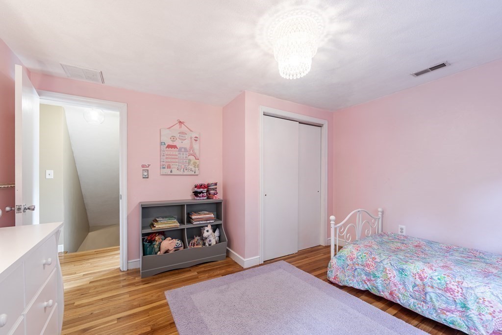 63 Maple Ridge Road Reading, MA 01867 - Photo 28 of 41 a bedroom with a bed and a dresser in it