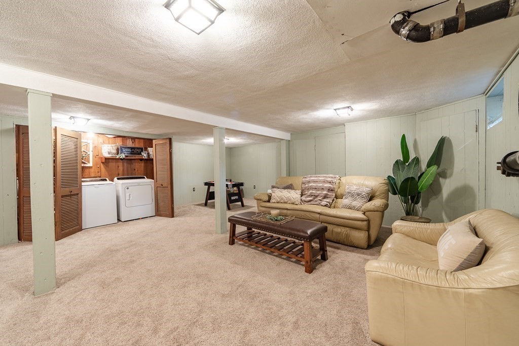 63 Maple Ridge Road Reading, MA 01867 - Photo 33 of 41 a living room with furniture and white walls