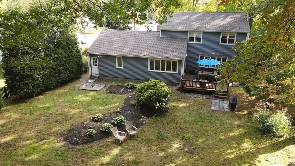 63 Maple Ridge Road Reading, MA 01867 - Photo 36 of 41 a aerial view of a house with table and chairs and a barbeque