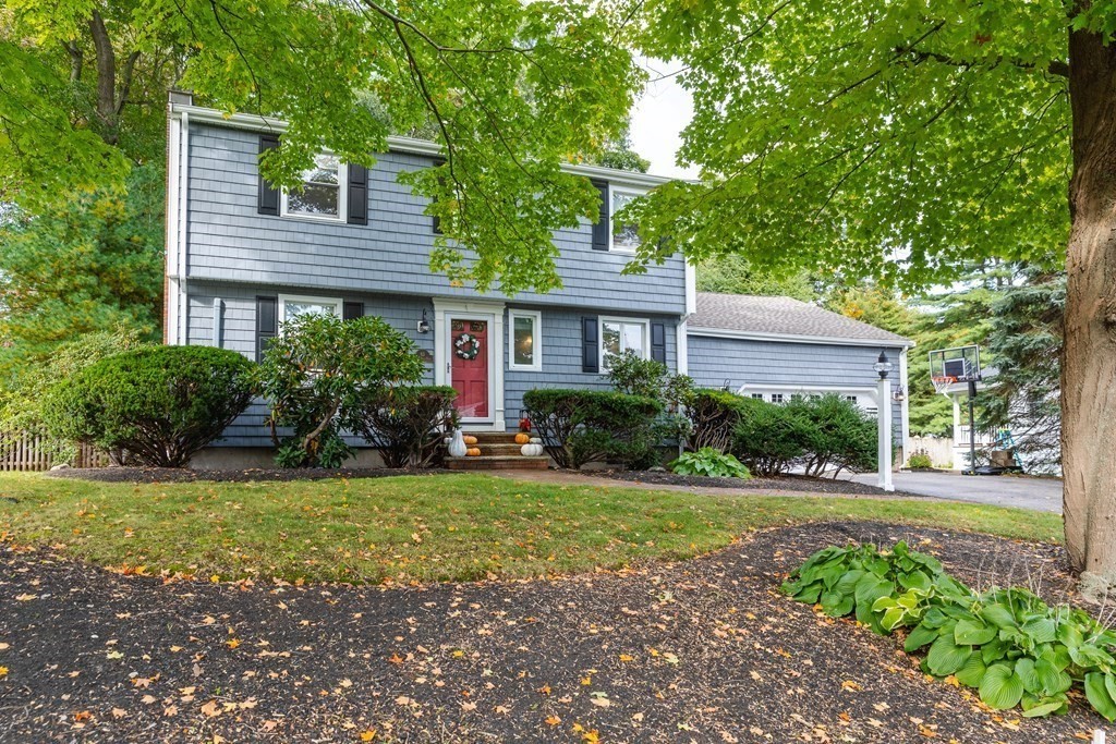 63 Maple Ridge Road Reading, MA 01867 - Photo 39 of 41 a front view of a house with a yard