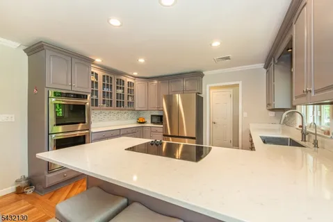 a kitchen with stainless steel appliances granite countertop a sink and a microwave