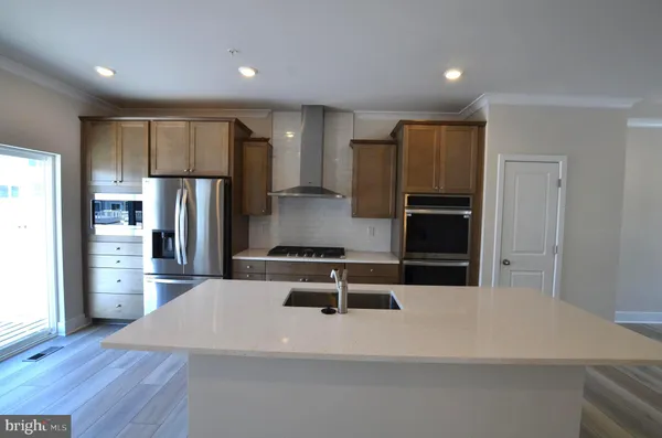 a kitchen with stainless steel appliances a refrigerator and a stove