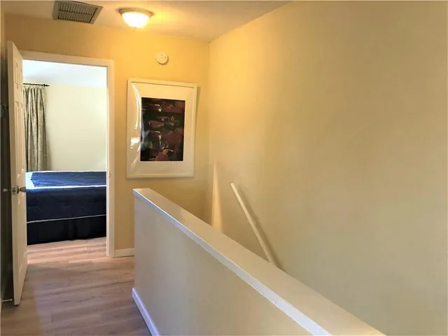 a bedroom with a bed and a lamp next to a window