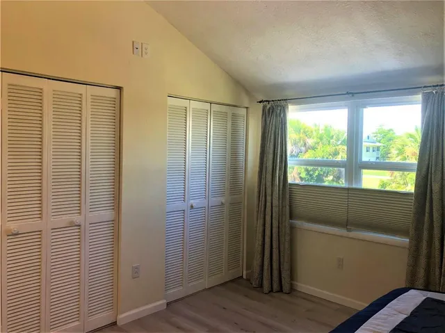 a workspace with wooden floor and a window