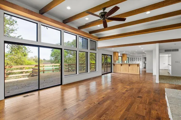 a kitchen with a sink and wooden floor