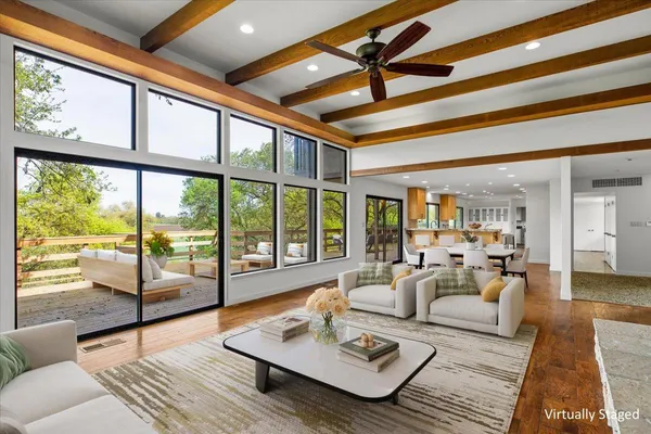 a kitchen with a sink refrigerator and wooden floor