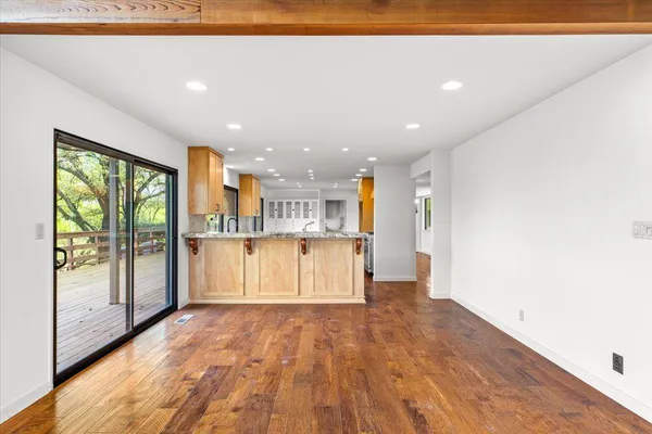 a kitchen with kitchen island granite countertop a sink stove and refrigerator