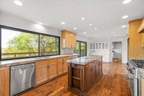 a kitchen with stainless steel appliances granite countertop a stove and a refrigerator