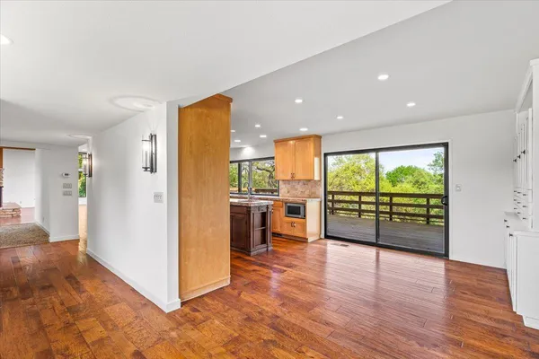 a view of entryway with wooden floor and windows